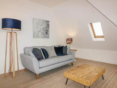 a living room with a couch and a table at Crabs and Lobsters in Newquay