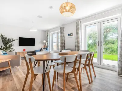 a dining room with a table and chairs at Chi Gwynn in Newquay