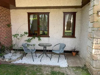 a table and two chairs and a table and two windows at 44 Trevithick view in Saint Erth