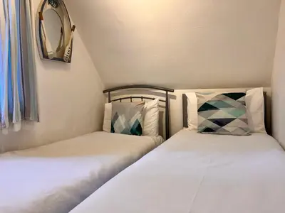 two beds sitting next to each other in a room at 44 Trevithick view in Saint Erth
