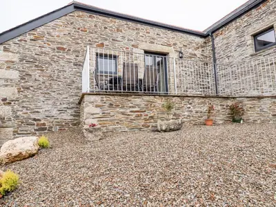 a brick building with a balcony on the side of it at The Hayloft in Bodmin