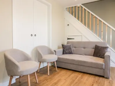 a living room with a couch and two chairs at The Granary in Bodmin