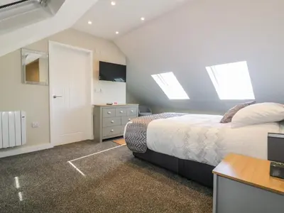 a bedroom with a bed and skylights at The Cornstore in Bodmin