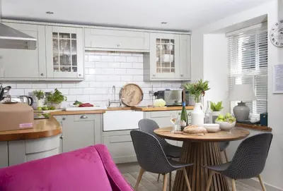 a kitchen with a table and chairs in a kitchen at Oriel Cottage in St. Agnes