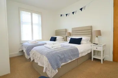 a bedroom with two beds and a window at Padstow townhouse, close to harbour in Padstow