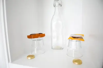 a bottle and two glasses and some coins at No 10 Treverbyn Road B & B in Padstow