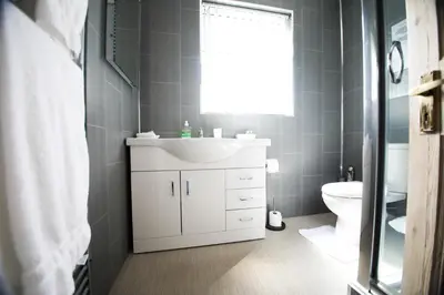 a bathroom with a white sink and a toilet at No 10 Treverbyn Road B & B in Padstow