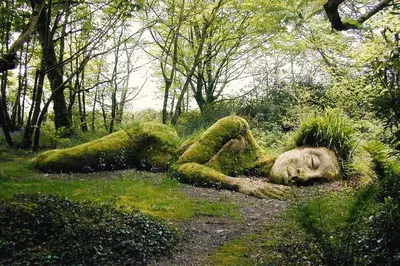 a statue of a person laying in the grass at Shabby Shack near Charlestown & The Eden Project in St Austell