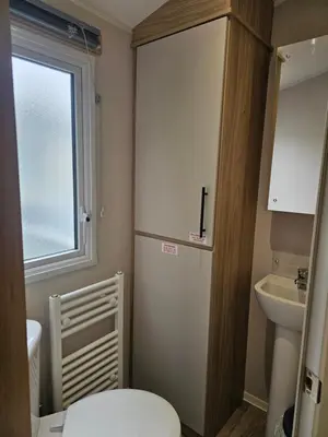 a small bathroom with a toilet and a sink at Mawgan Pads Trevella Crantock in Crantock