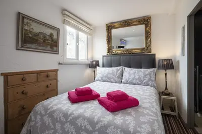 a bedroom with two pink pillows on a bed at Cornerways Guest House in St Ives
