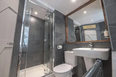 a bathroom with a toilet and a sink and a shower at Cornerways Guest House in St Ives