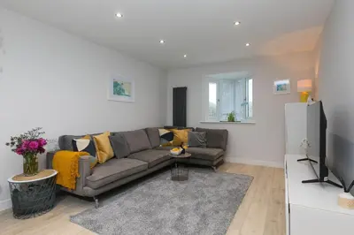 a living room with a couch and a tv at Chi Lowen in Carbis Bay