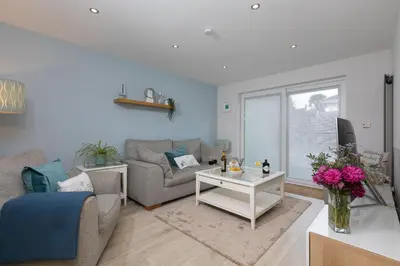 a living room with a couch and a table at Chi Lowen in Carbis Bay