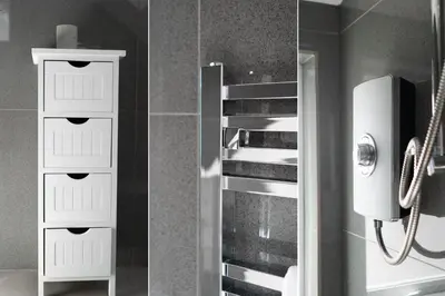 two pictures of a bathroom with a shower at Beached Az in St Ives