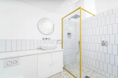 a white bathroom with a sink and a mirror at Mavericks in St Ives