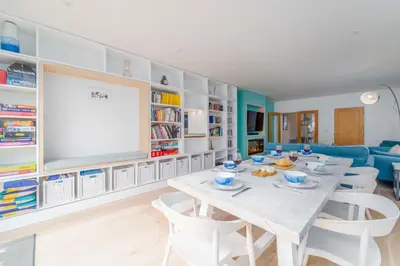 a dining room with a white table and chairs at Mavericks in St Ives