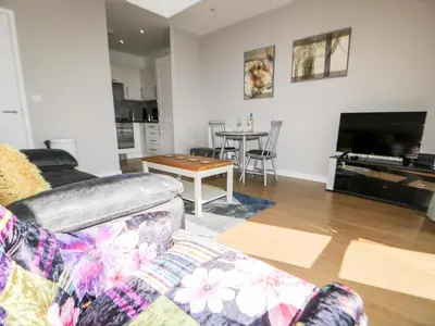 a living room with a couch and a table at 23 Tre Lowen in Newquay