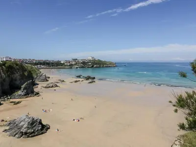 a beach with people on the sand and the ocean at 23 Tre Lowen in Newquay