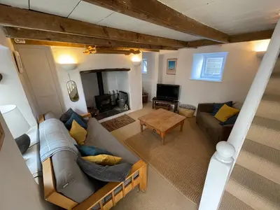 a living room with a couch and a table at Mapa Cottage in Mount Hawke