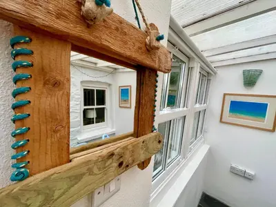 a window in a house with a wooden frame at Mapa Cottage in Mount Hawke