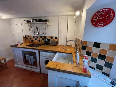 a kitchen with a sink and a stove top oven at Mapa Cottage in Mount Hawke