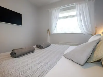 a bedroom with a bed with two pillows on it at Estuary View in Newquay