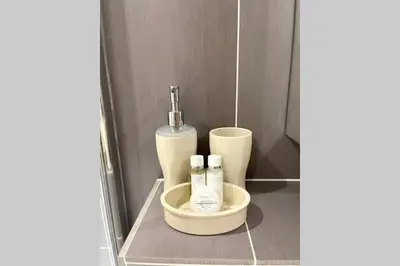 a bathroom with two bottles of soap in a sink at Luna Beach - Luxury Carbis Bay Apartment + Parking in Carbis Bay