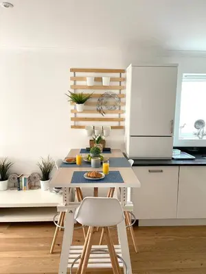 a small kitchen with a table and chairs at Luna Beach - Luxury Carbis Bay Apartment + Parking in Carbis Bay