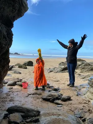 a woman and a child on a beach at Rose Cottage Bee Happy anex in Newquay