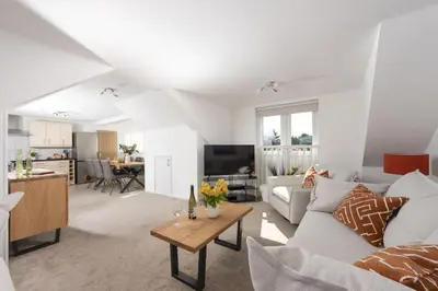 a living room with a couch and a table at Bridge Apartment - Free Parking & WiFi - Near Perranporth Beach in Perranporth