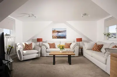 a living room with white couches and a coffee table at Bridge Apartment - Free Parking & WiFi - Near Perranporth Beach in Perranporth