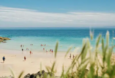 a group of people playing in the water on a beach at 8 Fernhill in Carbis Bay