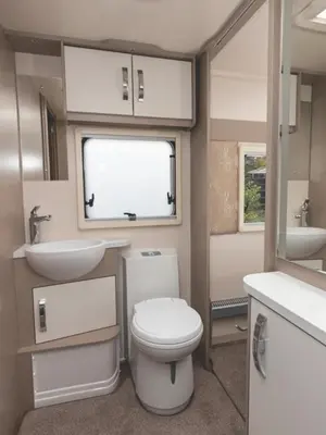 a small bathroom with a toilet and a sink at Pinetum Gardens Retreats in St Austell