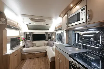 an rv with a kitchen and a sink in it at Pinetum Gardens Retreats in St Austell