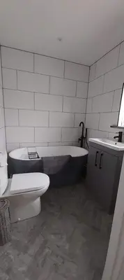 a bathroom with a tub and a toilet and a sink at Newquay Rialton Holiday Home in Newquay