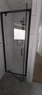 a glass door in a room with a window at Newquay Rialton Holiday Home in Newquay