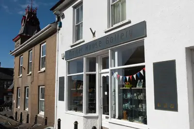 a store front of a building with a window at Greenfields Coach House - Balcony with stunning ocean view in Marazion