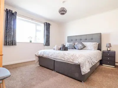 a bedroom with a large bed and a window at Summerhayes in Redruth