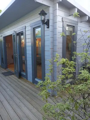 a house with glass doors on a deck at Sandy Toes Accommodation in Par