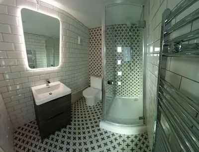 a bathroom with a sink and a shower and a toilet at Sandy Toes Accommodation in Par