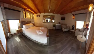 a bedroom with a large bed in a room at Sandy Toes Accommodation in Par