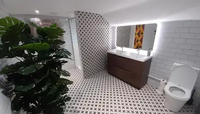 a bathroom with a sink and a toilet and a mirror at Sandy Toes Accommodation in Par