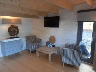 a living room with two chairs and a table at Sandy Toes Accommodation in Par