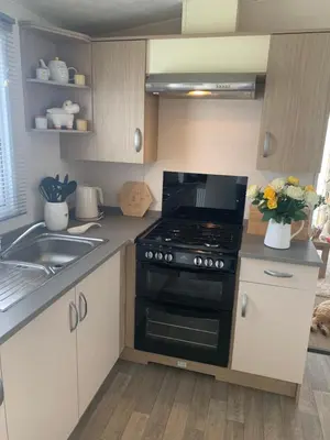 a small kitchen with a stove and a sink at Bude 13 in Cubert