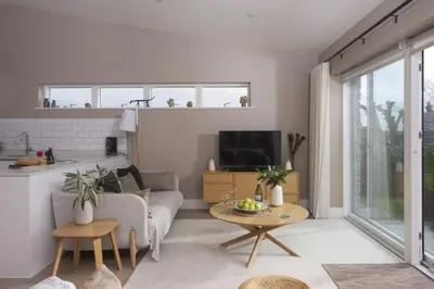 a living room with a couch and a table at Salt Life, Dunes at Upton Towans - Hot tub - Pet friendly - Self check in in Hayle