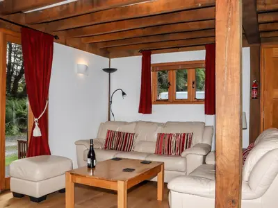 a living room with a white couch and a table at Bybrook Lodge in Camelford