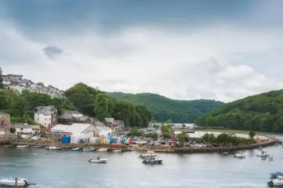 a town with boats in a body of water at Large House in Looe, Near Beach and Bars with Great Views, Free Parking and Free Access to a Nearby Indoor Swimming Pool in Looe