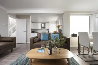 a living room with a couch and a table at Fairsky - Sea Views and Allocated Parking in Carbis Bay