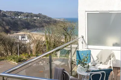 a balcony with chairs and a view of the ocean at Fairsky - Sea Views and Allocated Parking in Carbis Bay