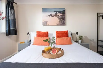 a bedroom with a bed with a bowl of fruit on it at Fairsky - Sea Views and Allocated Parking in Carbis Bay